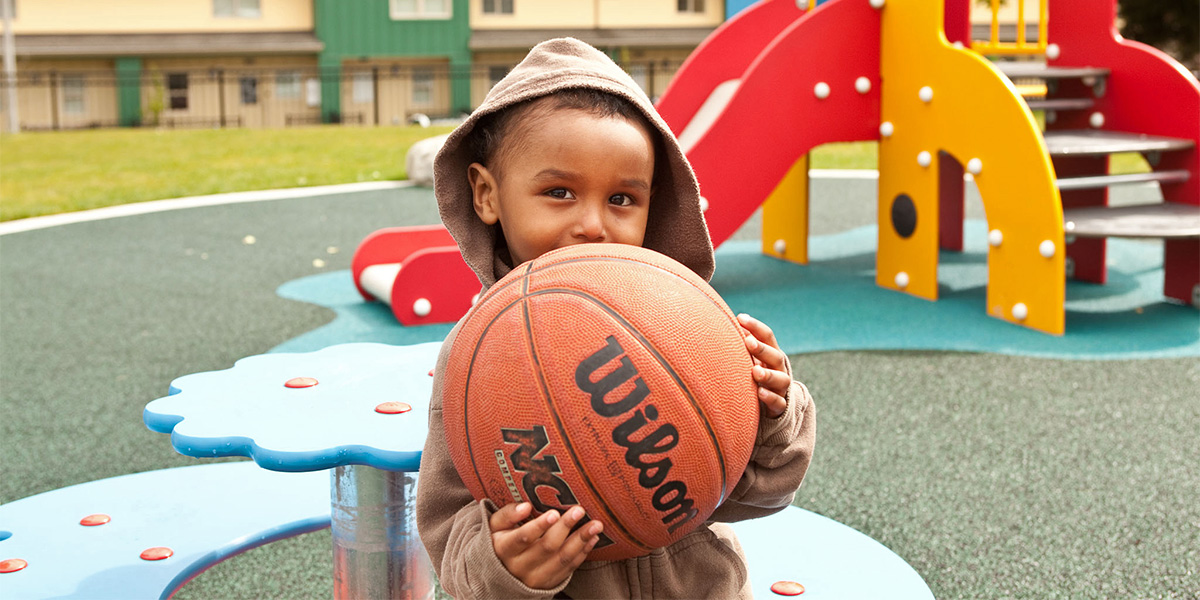 Boy holding basketball at Birch Creek in Kent