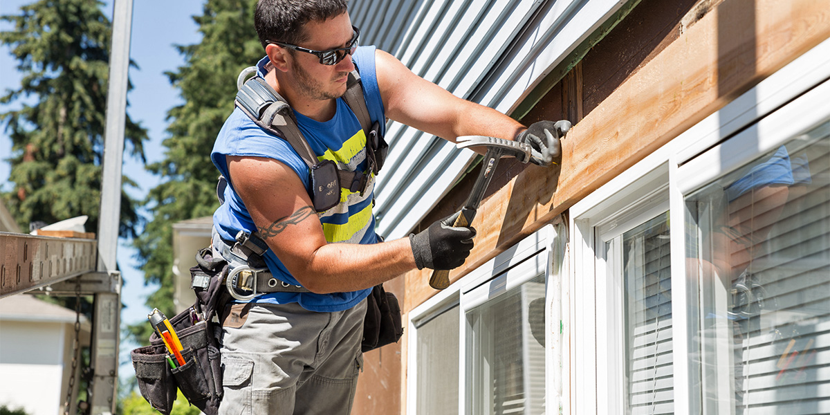 Construction worker performing building repair